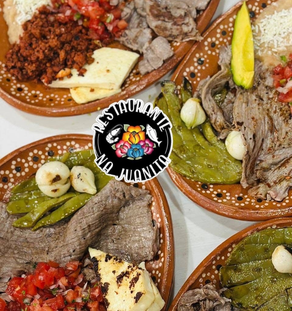 Platos tradicionales de Restaurante Na’ Juanita en Lachigoló, Oaxaca, con tasajo, chorizo, queso asado, nopal asado, cebollitas y guarniciones típicas del Istmo.