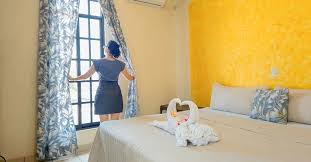Habitación con camas matrimoniales decoradas con toallas en forma de cisne y tonos azules en el Hotel Central de Juchitán